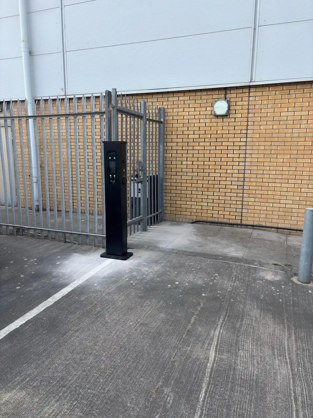 EV charging pedestal installed in a commercial parking bay