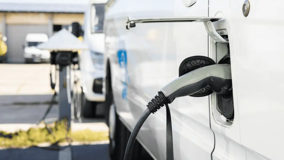 EV charger plugged into a fleet vehicle in a commercial car park