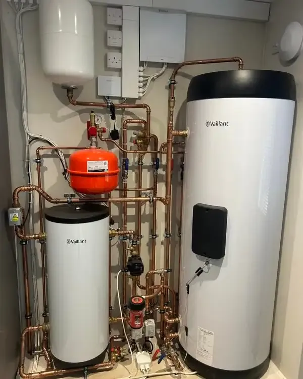 Hot water cylinder and expansion vessel piped up in a plant cupboard