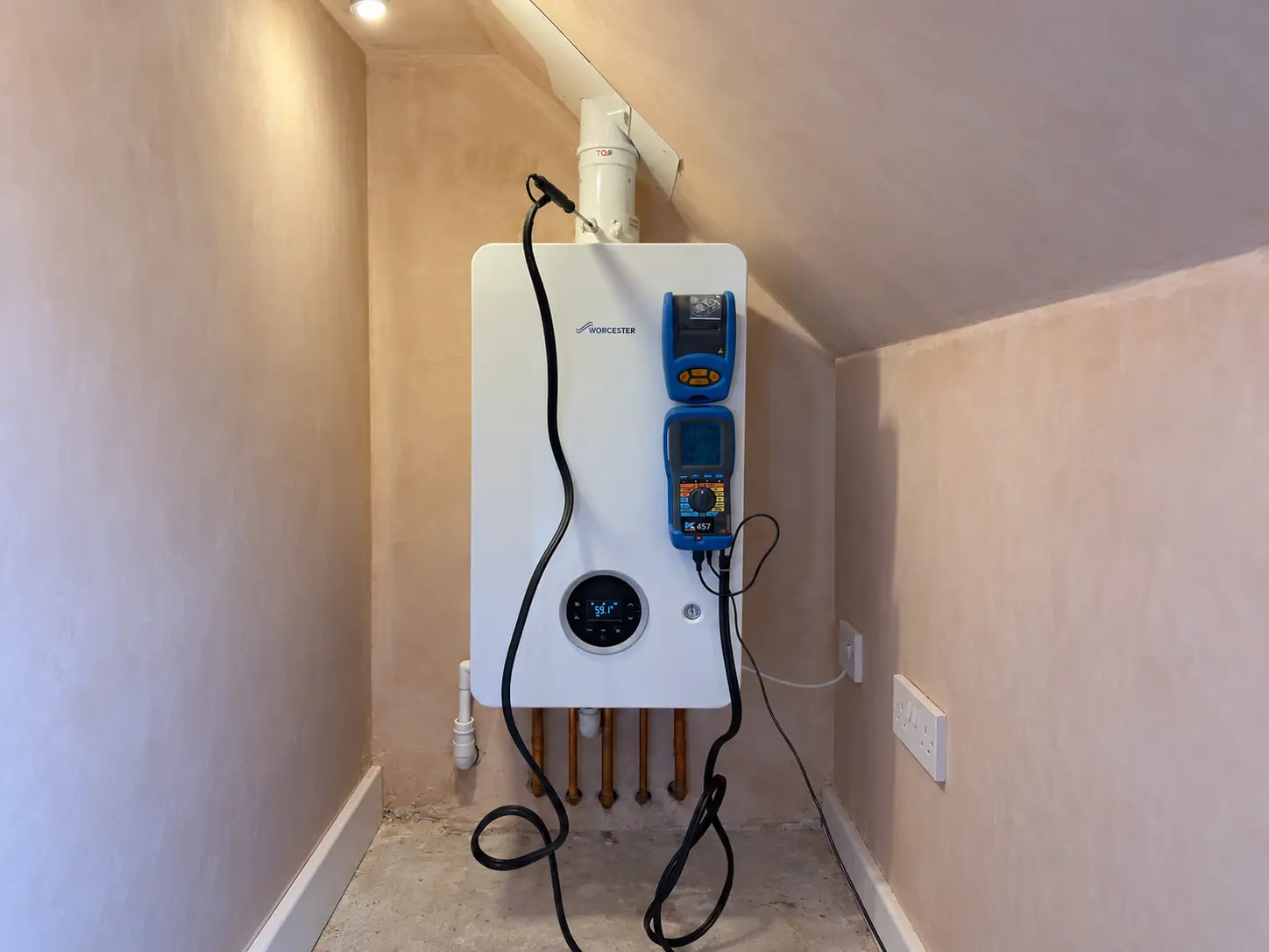 Worcester Bosch wall-mounted boiler being commissioned with flue gas analysis equipment